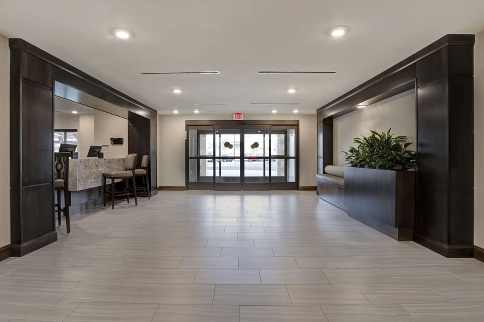 Open lobby entrance with greenery and natural light.