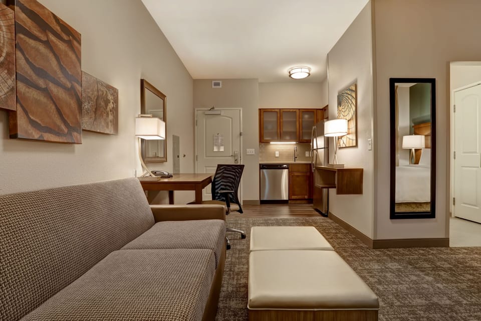 Studio suite with sofa, dining area, and stylish decor.
