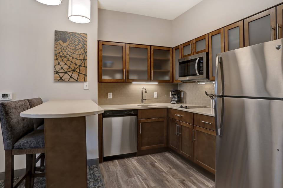 Fully equipped kitchen with modern appliances and dining area.