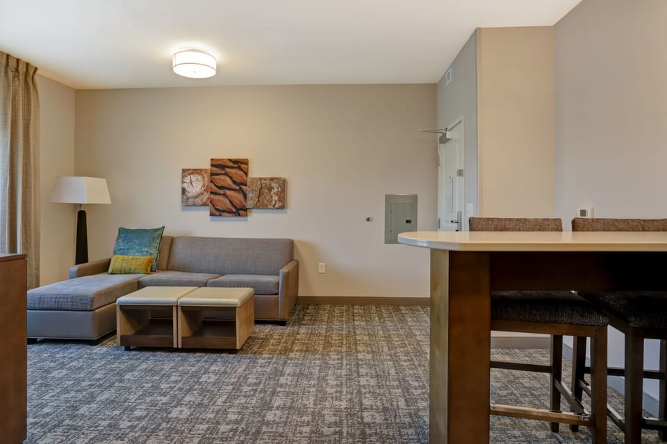 Cozy seating area with sofa, work desk, and TV.