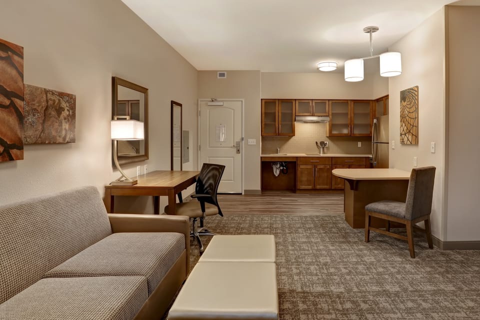 Living area with sofa, dining table, and integrated kitchen.