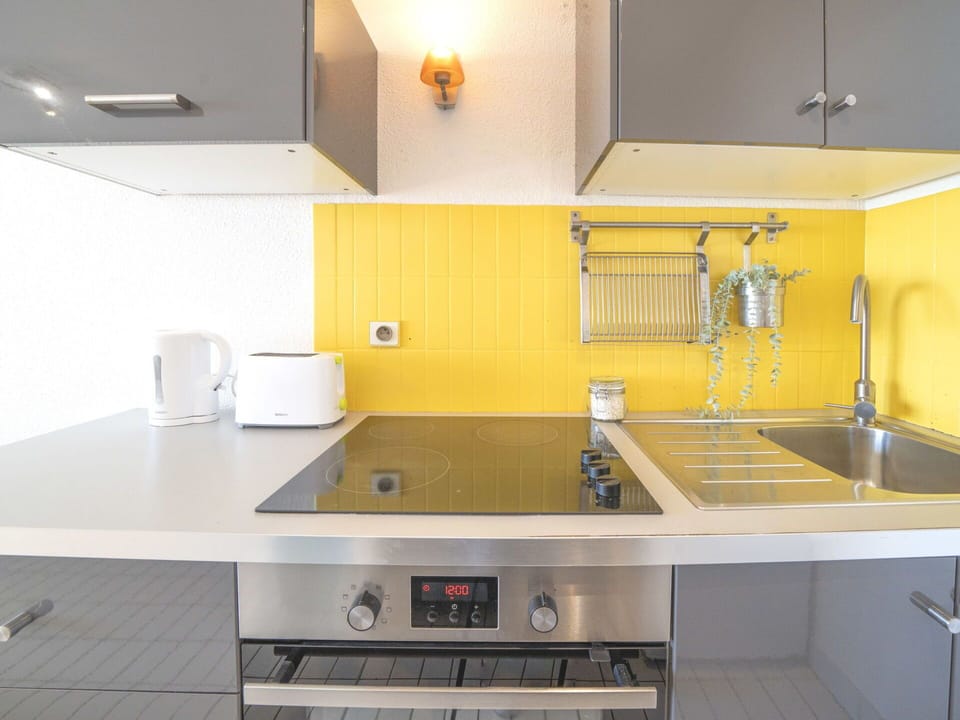 Kitchen, Countertop, Kitchen Appliance, Kitchen Sink, Interior Design, Major Appliance, Flooring, Yellow, Cabinetry, Plumbing Fixture