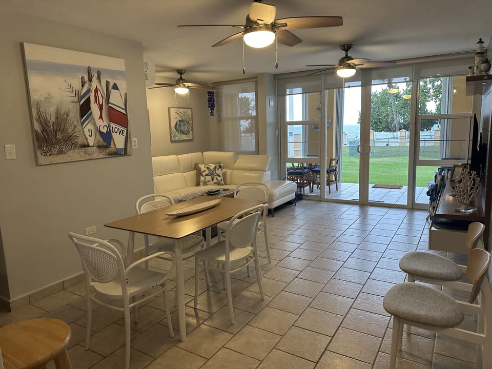 Dining and Living room area with ceiling fans, AC and SmartTV.
