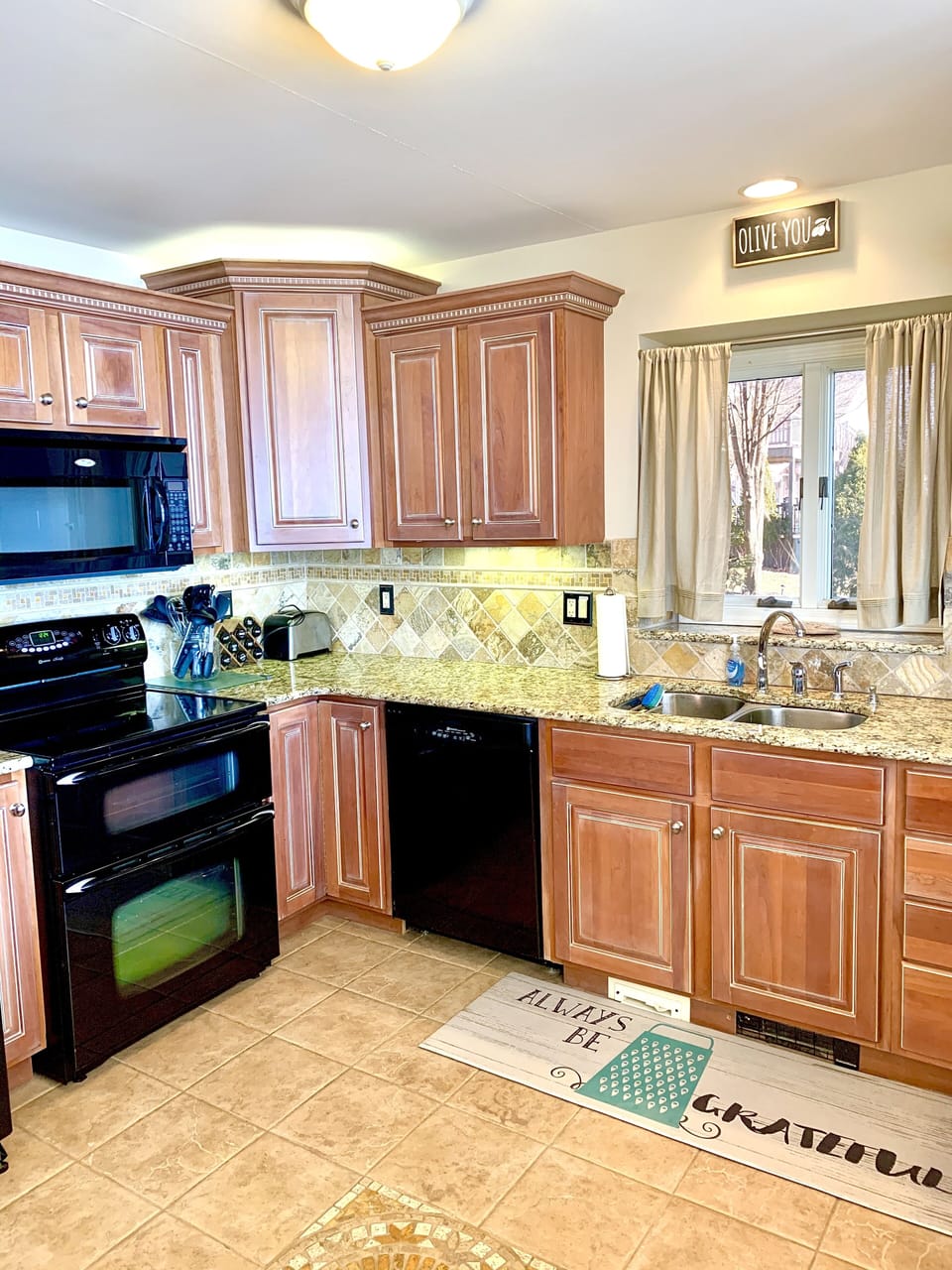 Kitchen with double oven, dishwasher, garbage disposal, double door refrigerator