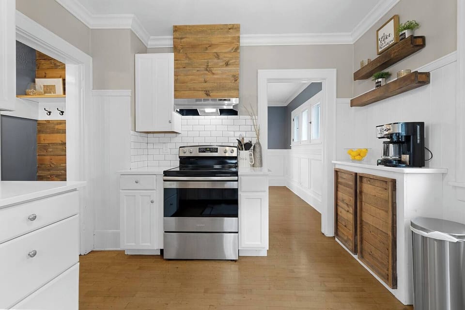 White quartz countertops and stainless steel appliances make this space feel fresh and clean.