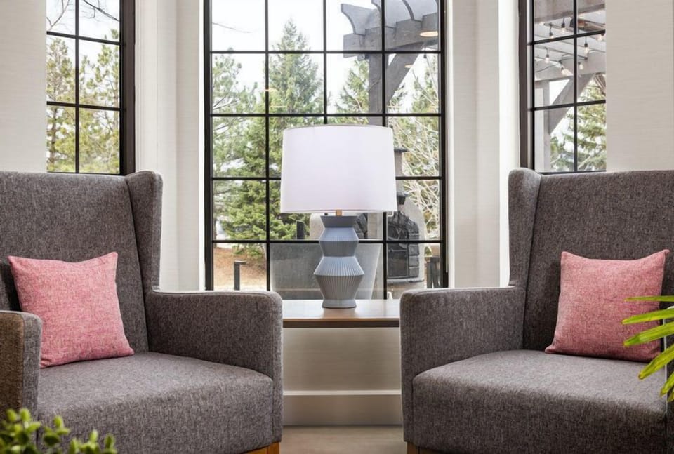 Relax in the cozy seating area, where natural light pours in through grand windows.