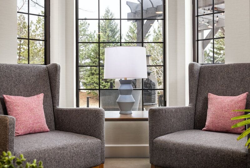 Relax in the cozy seating area, where natural light pours in through grand windows.