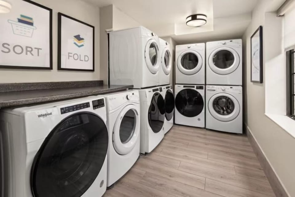 Guest laundry with multiple washers and dryers available on-site — paid service
