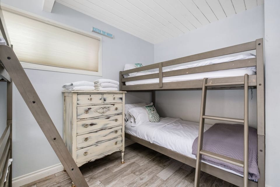 upstairs bedroom with full bunk bed over twin bed