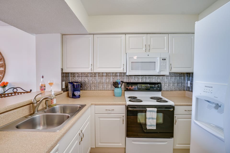 Fully equipped kitchen with Keurig coffee maker.