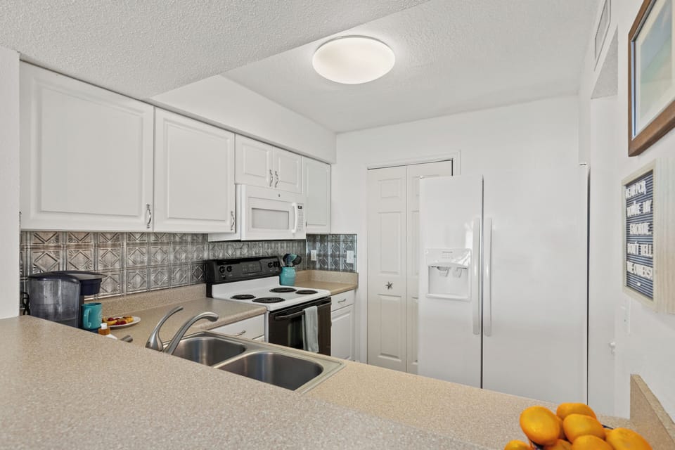 Full size refrigerator.  Washer and dryer in closet connected to kitchen.
