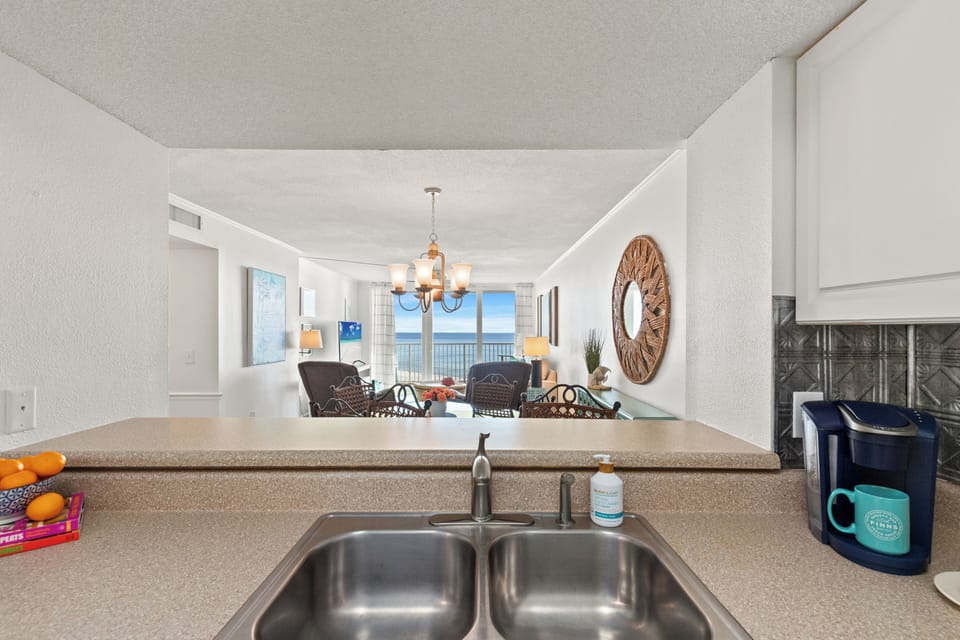 View from kitchen: main living and dining area then on to the water!