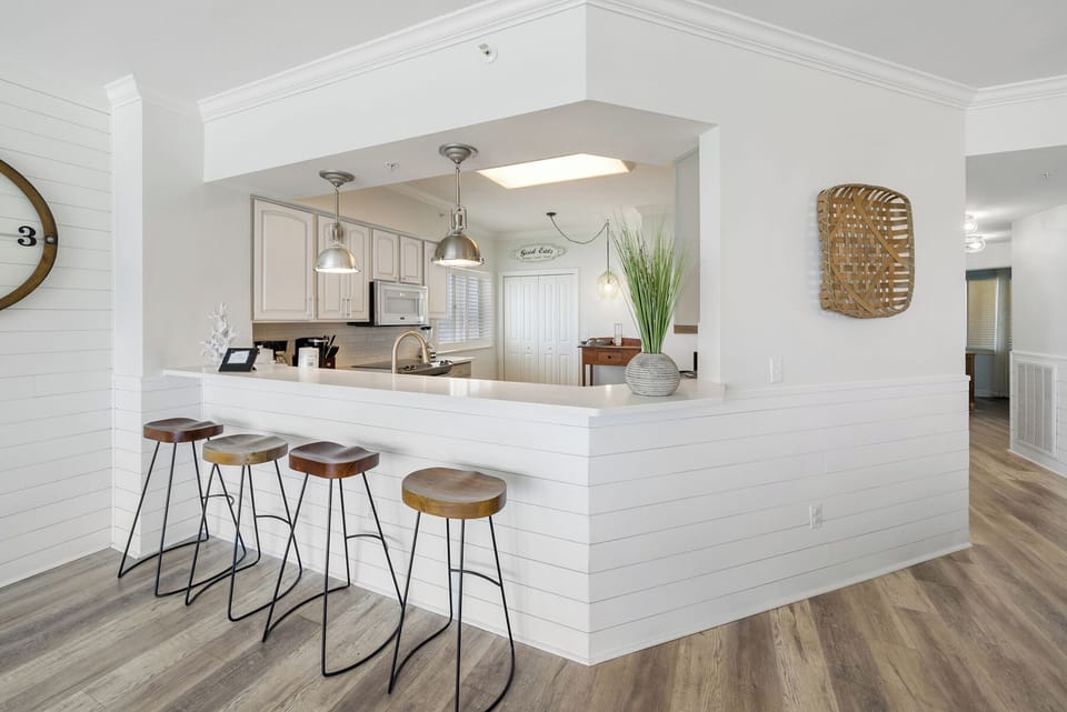 Your modern kitchen island invites morning coffee conversations with stylish seating and elegant pendant lighting overhead.