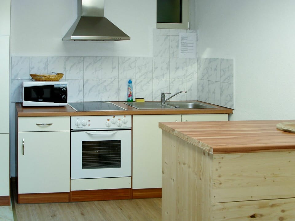 Countertop, Kitchen, Furniture, Room, Cabinetry, Kitchen Stove, Property, Kitchen Appliance, Material Property, Interior Design