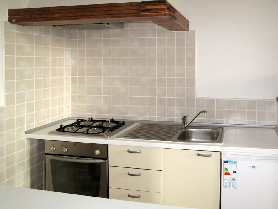 Room, Property, Countertop, Kitchen, Kitchen Stove, Cabinetry, Tile, Furniture, Gas Stove, Material Property