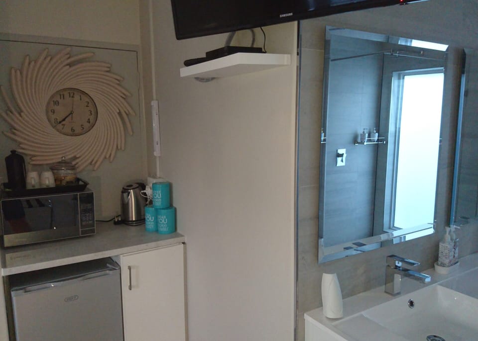 small kitchenette with essentials; microwave, kettle & fridge
