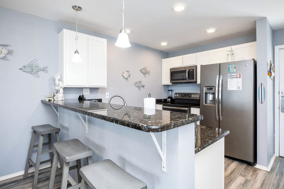 Well-equipped kitchen with modern appliances and  breakfast bar