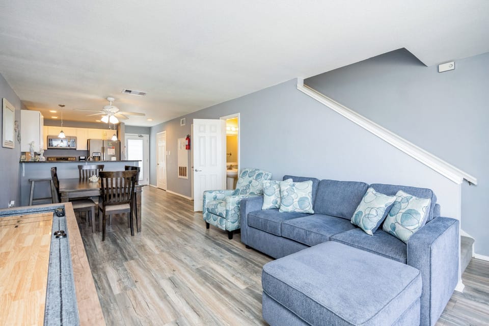 The kitchen, dining, and living areas blend together seamlessly for a bright and airy feel