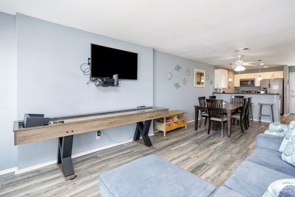 Cozy living area with shuffle board and flat screen TV