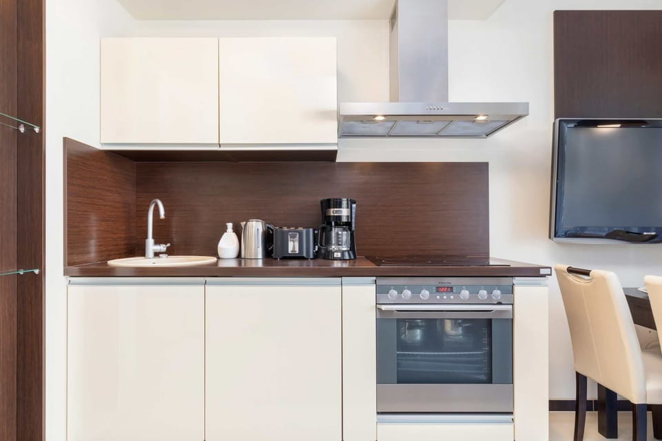 Kitchenette with oven and refrigerator. 