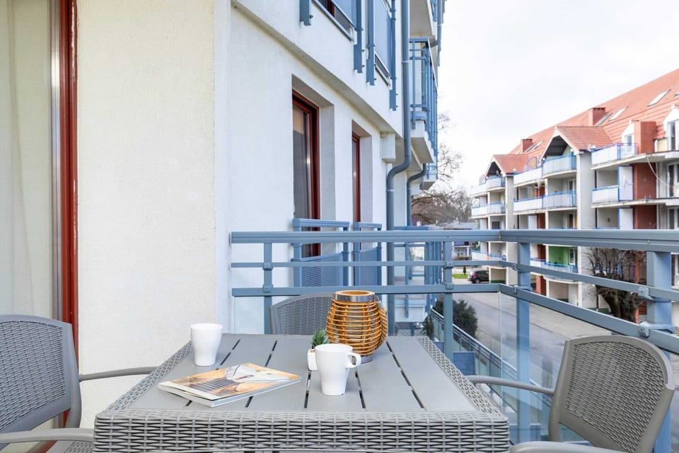 Furnished balcony with green surroundings. 