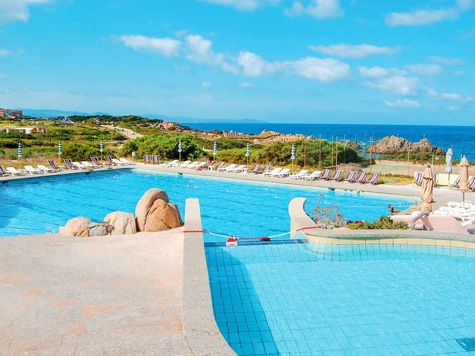 Water, Sky, Cloud, Azure, Blue, Seaside Resort, Outdoor Furniture, Coastal And Oceanic Landforms, Swimming Pool