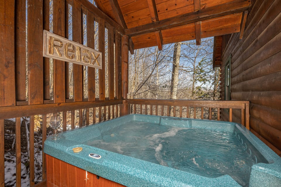 Hot tub on our private back deck. 2 chairs and a small table nearby