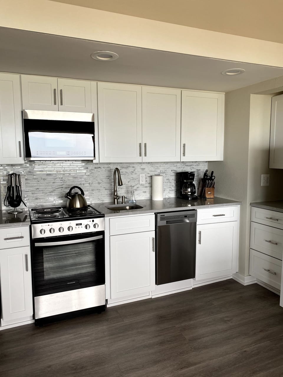 Updated kitchen with new cabinets, countertops, backsplash, paint,  & appliances