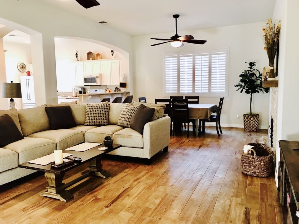 Living room area: Large comfy sectional, smart TV, fireplace and dining area. 