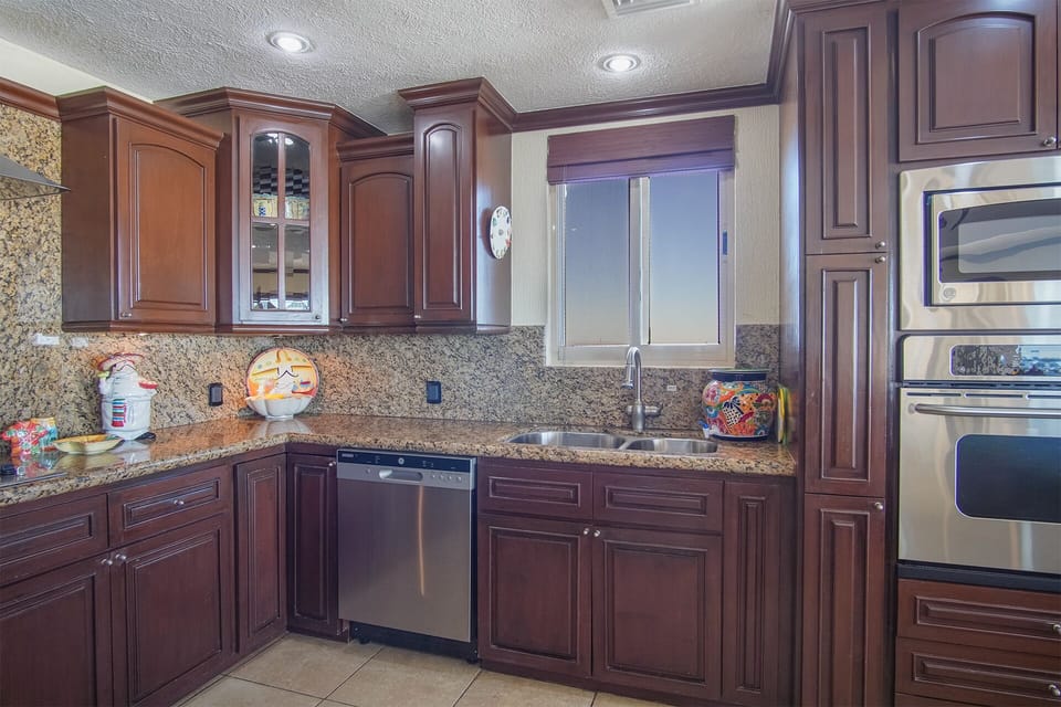 kitchen complete with stainless appliances and wine frig