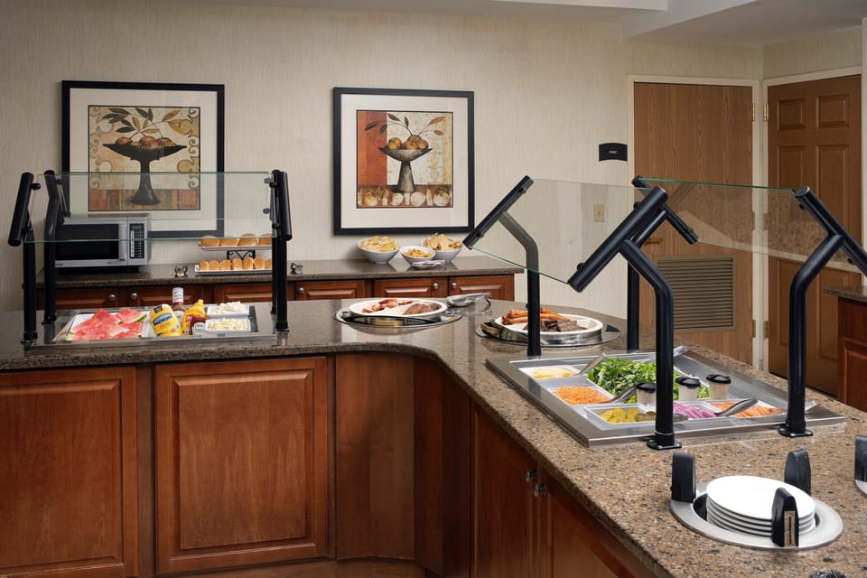 Breakfast buffet station with hot and cold food options.