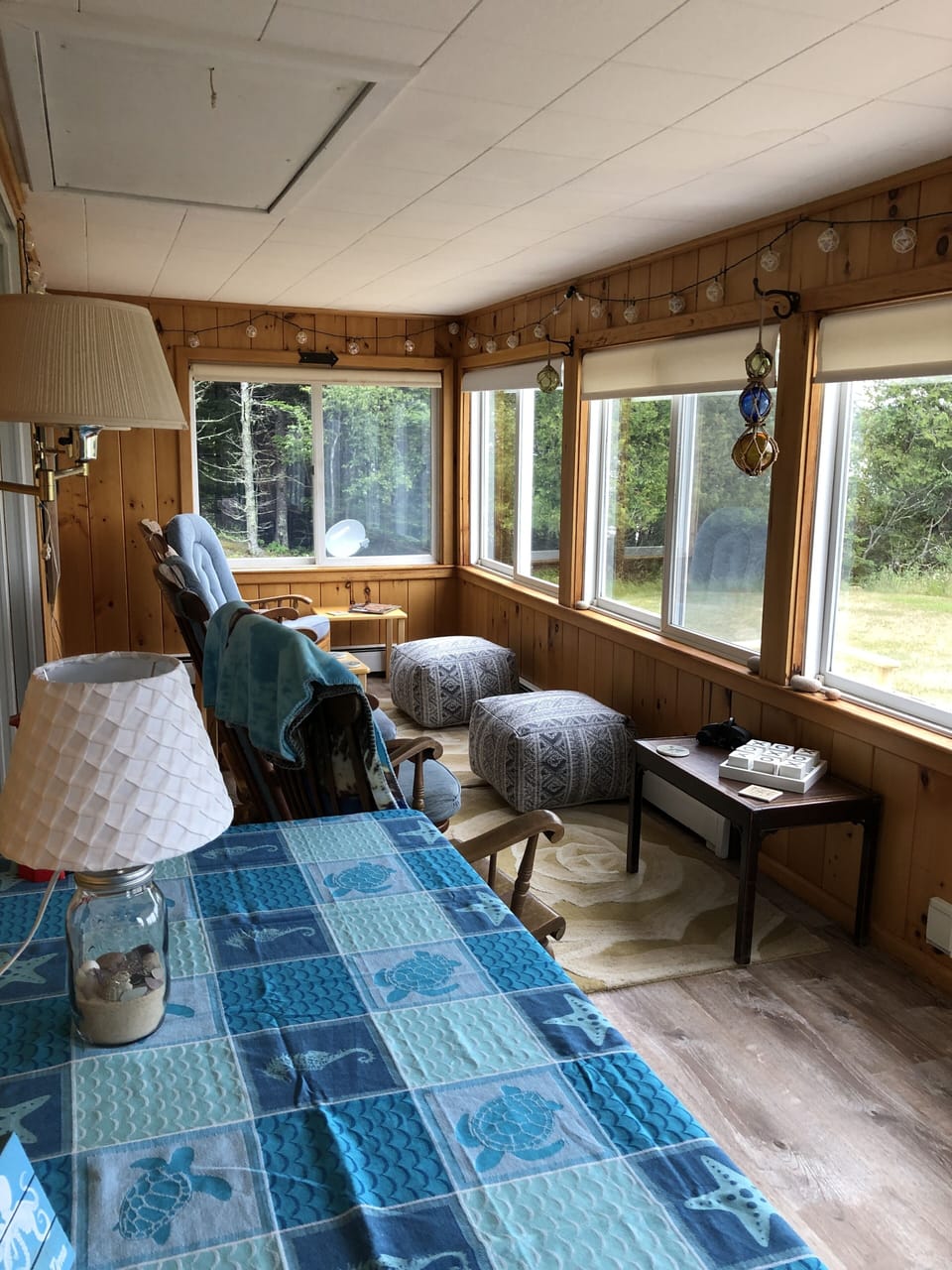 Enclosed porch with rocking chairs and a great view of the bay and lighthouse.  