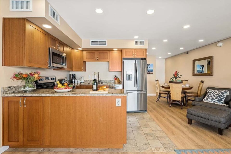 Spacious kitchen complete with stainless steel appliances and wooden cabinets