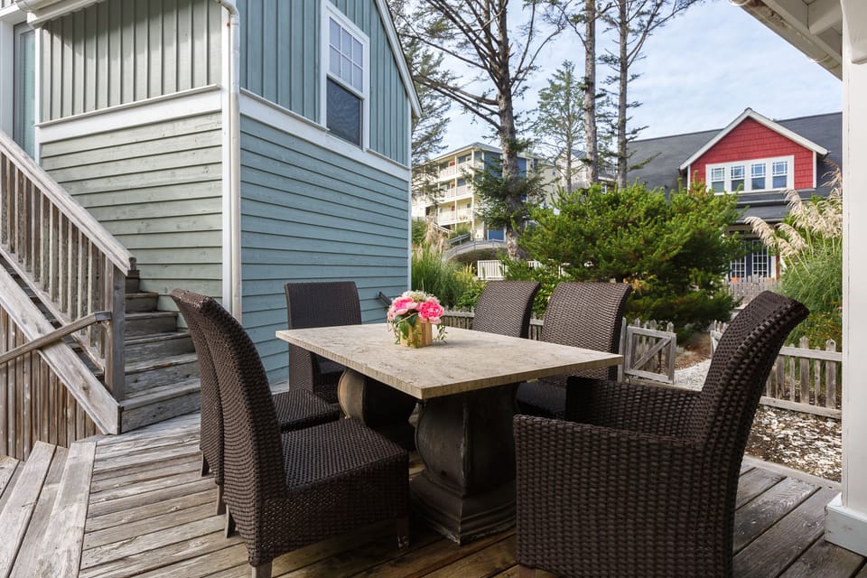 Dining table on the deck between carriage house and main house.