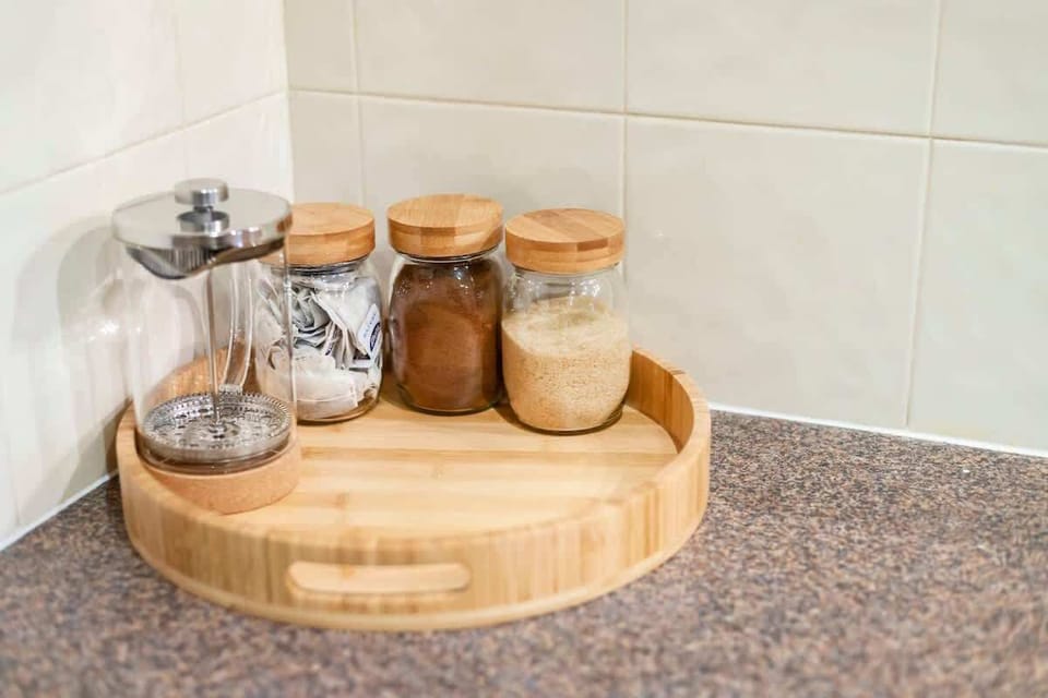 A warm welcome with complimentary coffee and tea. We've set out a coffee press and essentials like sugar and tea for your convenience.