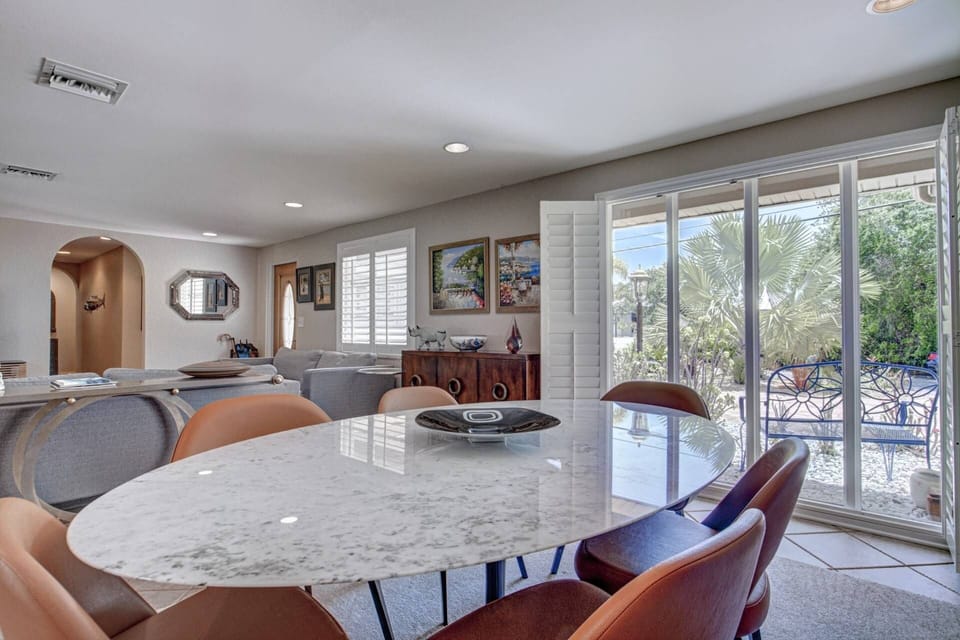 Indoor dining on a Saarinen Carrera marble table for 6 close to kitchen.  Enjoy home cooked meals with the gang!