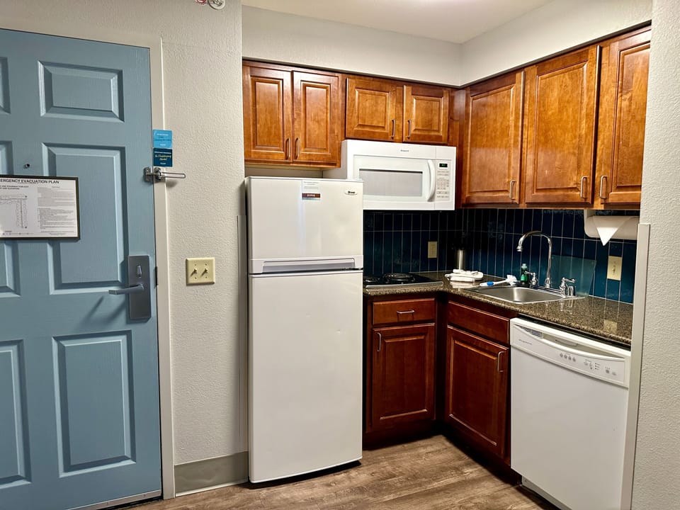 Fully equipped kitchen with microwave, dishwasher, and appliances.