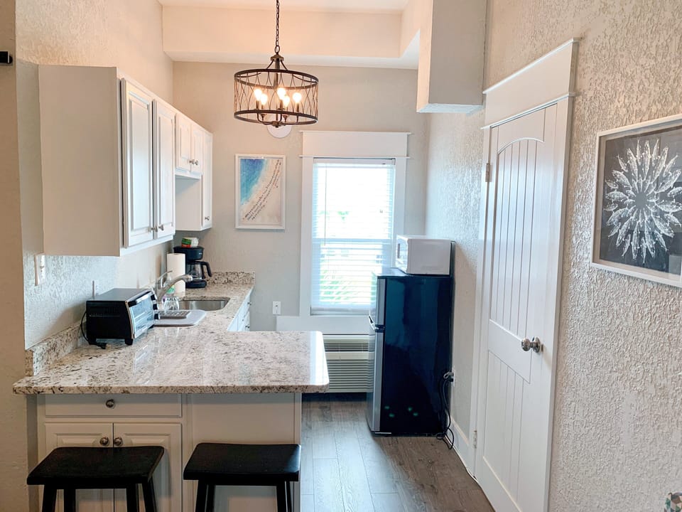 Kitchenette  view with seating at the bar for two.