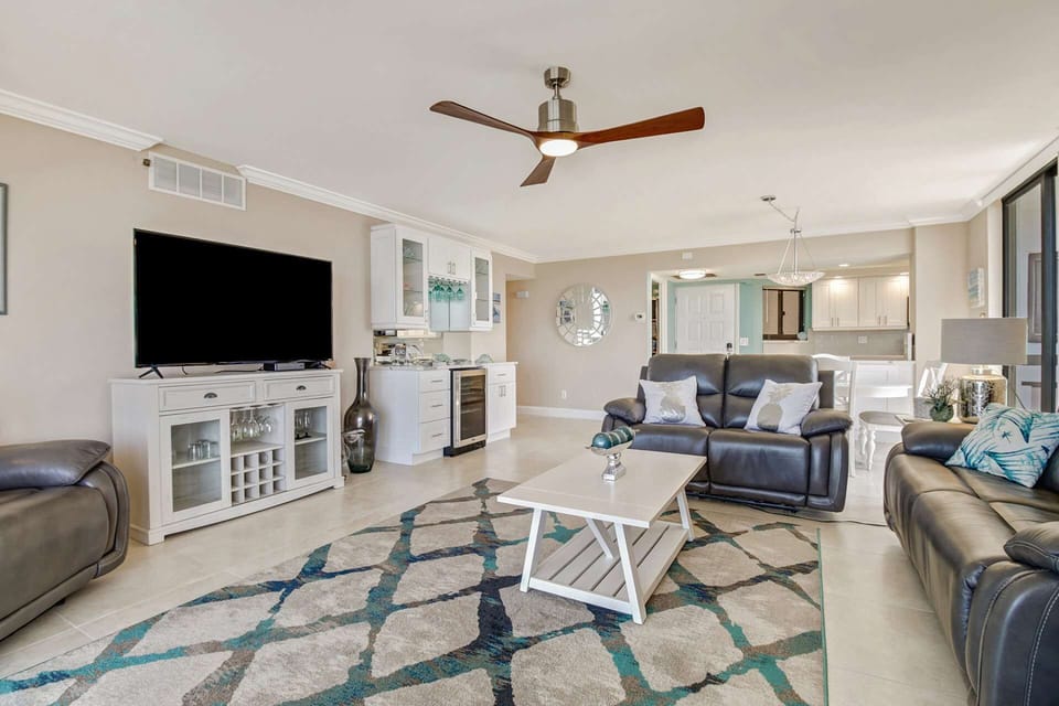 The open concept main living area features a large flatscreen TV with an advanced cable package.