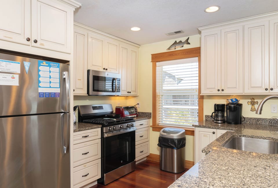 Your bright, spacious kitchen awaits with granite counters, stainless appliances, and everything you need to cook up coastal favorites during your stay.