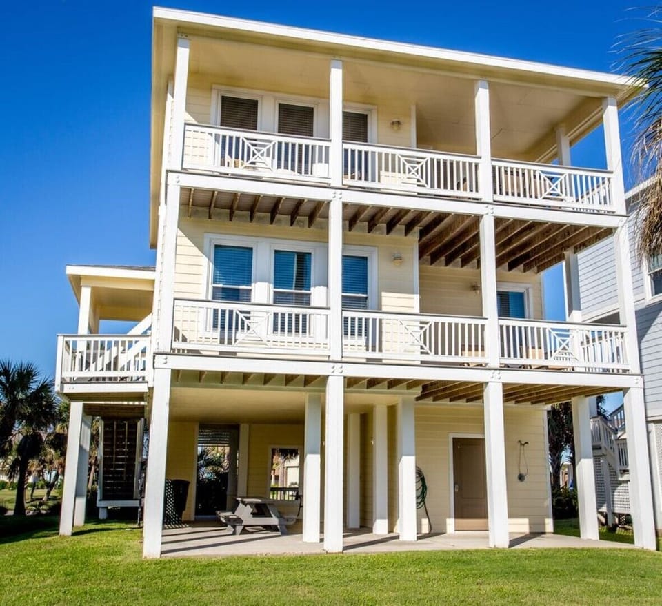 Back view of house faces pond. Top Deck off Living Room, Lower Deck off Master