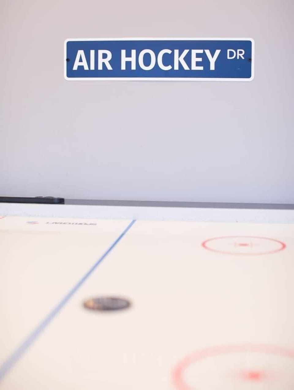 Face off in a friendly air hockey match in the shared rec space.
