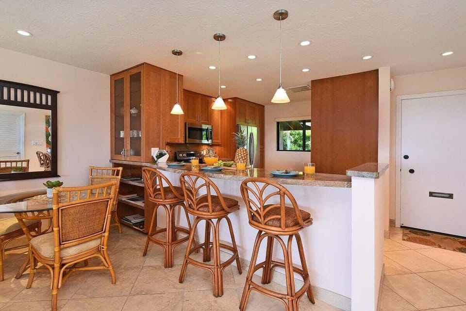 Spacious kitchen with a breakfast bar and seating for three—perfect for casual meals or morning coffee