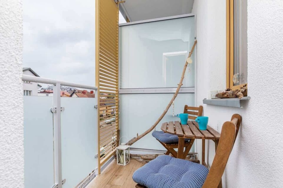 Spacious balcony with outdoor furniture. 