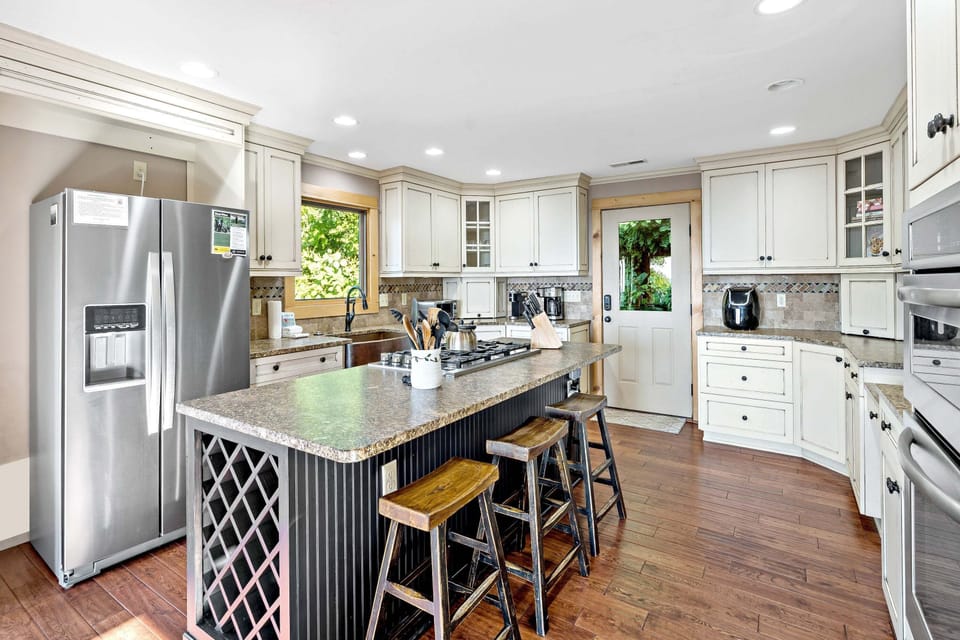 Spacious kitchen with double oven, pantry, oversized copper farm sink, five-burner propane gas stove, and 2 types of coffeemakers (Standard Drip & Keurig).