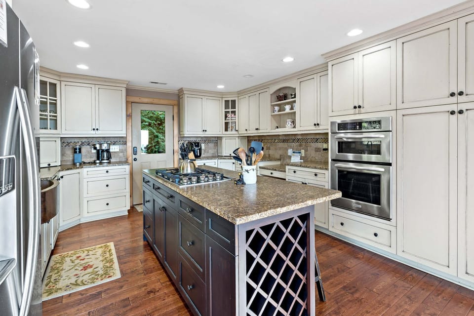 Spacious kitchen with double oven, pantry, oversized copper farm sink, five-burner propane gas stove, and 2 types of coffee makers (Standard Drip & Keurig).