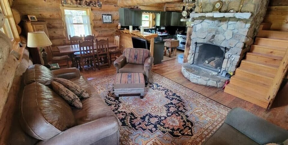 Living Room: Sofa, chair, sleeper chair, wood burning fireplace. 