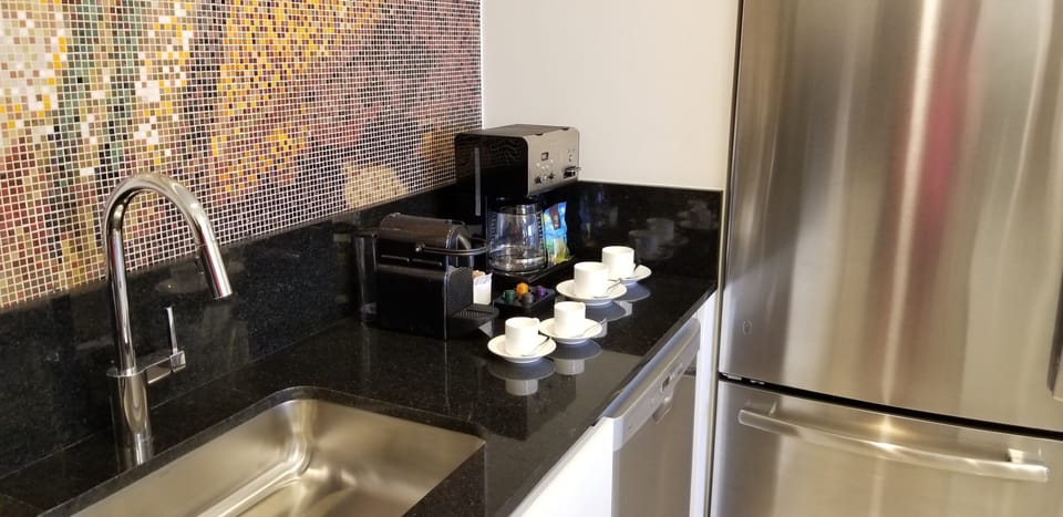 Kitchen amenities with coffee maker and Nespresso machine