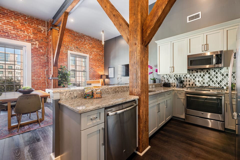 Cook and dine easily in the fully stocked kitchen, equipped with all stainless steel appliances, gas range, basic cookware, and a dining area for a comfortable meal at home. Entertain at the bar with seating for four.