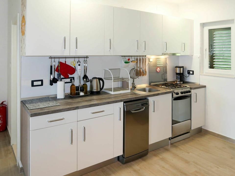 Countertop, Room, Kitchen, Property, Cabinetry, Furniture, Major Appliance, Building, Yellow, Interior Design
